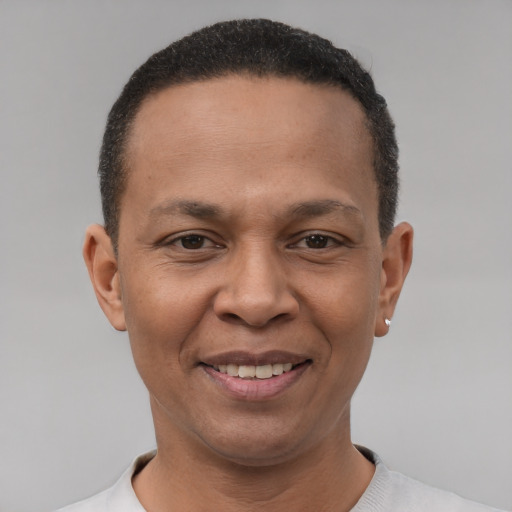 Joyful latino adult male with short  brown hair and brown eyes