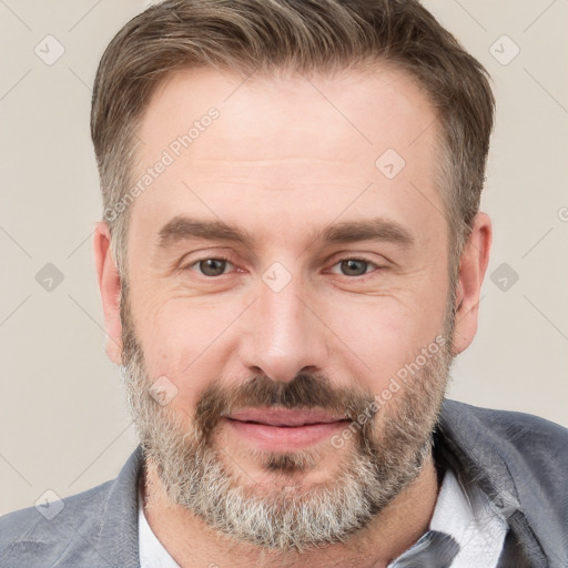 Joyful white adult male with short  brown hair and grey eyes