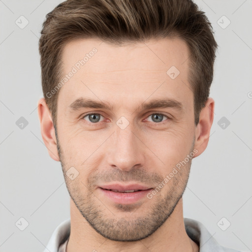 Joyful white young-adult male with short  brown hair and grey eyes