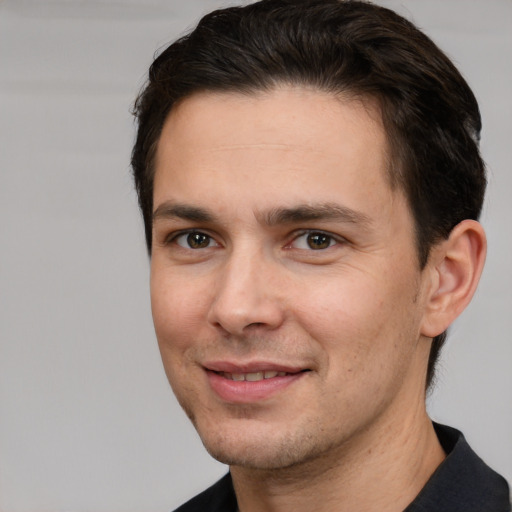 Joyful white adult male with short  brown hair and brown eyes