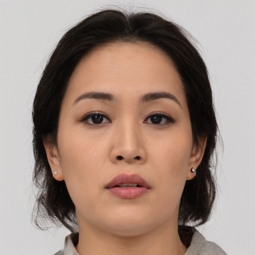 Neutral asian young-adult female with medium  brown hair and brown eyes