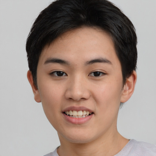 Joyful asian young-adult female with short  black hair and brown eyes