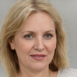 Joyful white adult female with medium  brown hair and blue eyes