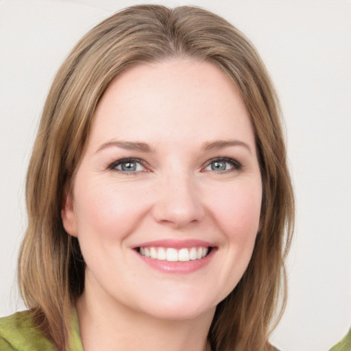 Joyful white young-adult female with medium  brown hair and green eyes