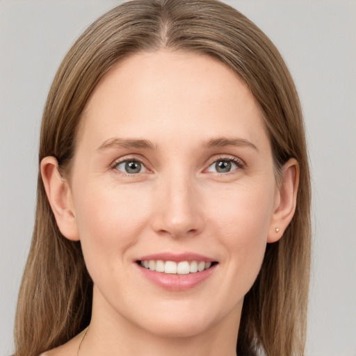 Joyful white young-adult female with long  brown hair and grey eyes