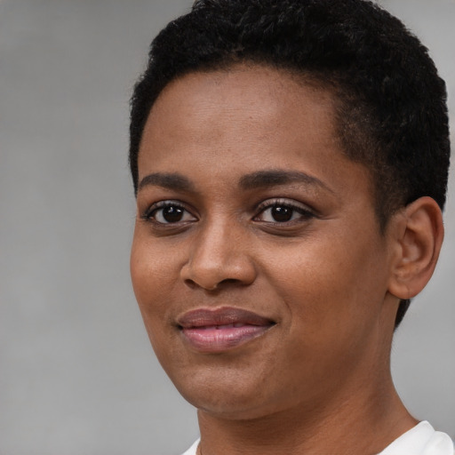 Joyful black young-adult female with short  brown hair and brown eyes