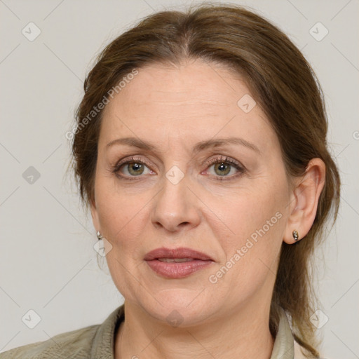 Joyful white adult female with medium  brown hair and grey eyes