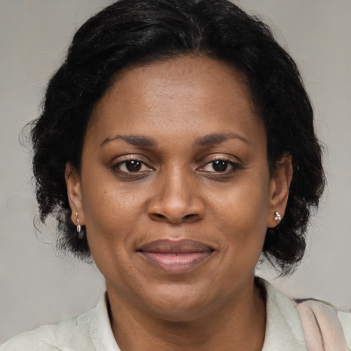 Joyful latino adult female with medium  brown hair and brown eyes