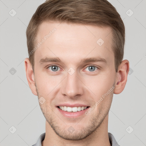 Joyful white young-adult male with short  brown hair and grey eyes