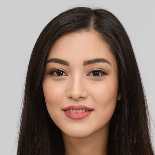Joyful asian young-adult female with long  brown hair and brown eyes