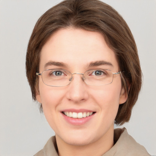 Joyful white adult female with medium  brown hair and green eyes