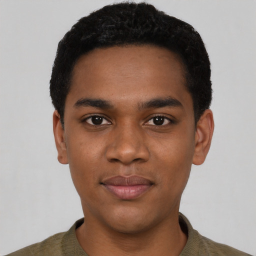 Joyful black young-adult male with short  black hair and brown eyes