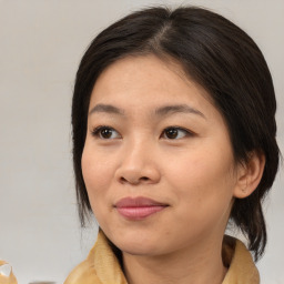 Joyful asian young-adult female with medium  brown hair and brown eyes