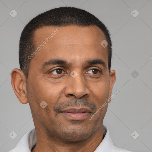 Joyful latino adult male with short  black hair and brown eyes