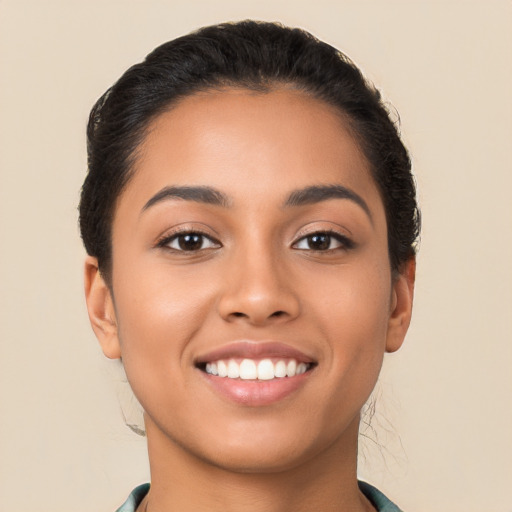 Joyful latino young-adult female with long  black hair and brown eyes