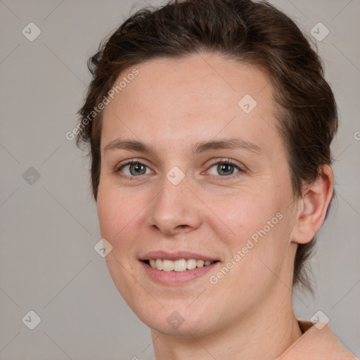 Joyful white young-adult female with medium  brown hair and grey eyes