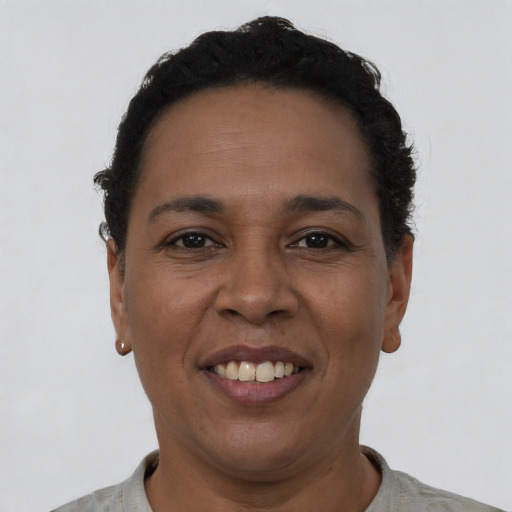 Joyful latino adult female with short  black hair and brown eyes