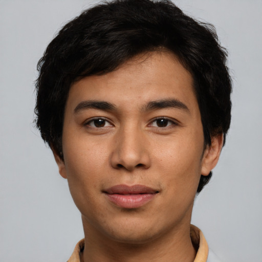 Joyful latino young-adult male with short  brown hair and brown eyes