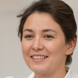 Joyful white adult female with medium  brown hair and brown eyes