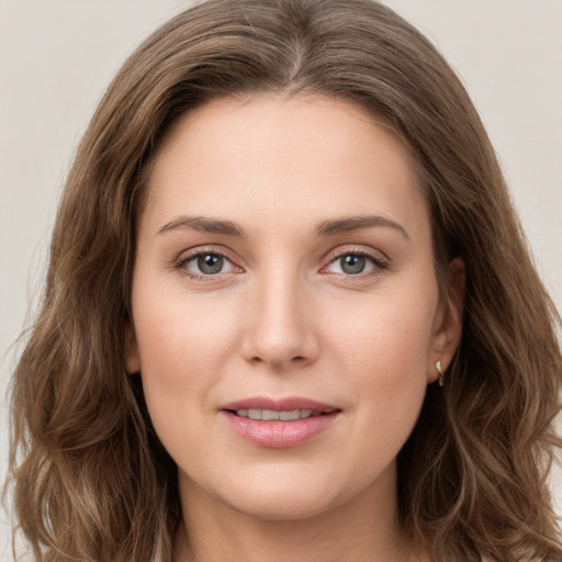 Joyful white young-adult female with long  brown hair and green eyes