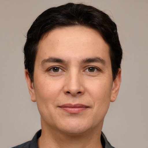 Joyful white adult male with short  brown hair and grey eyes