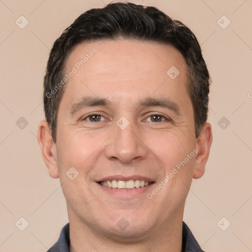 Joyful white adult male with short  brown hair and brown eyes