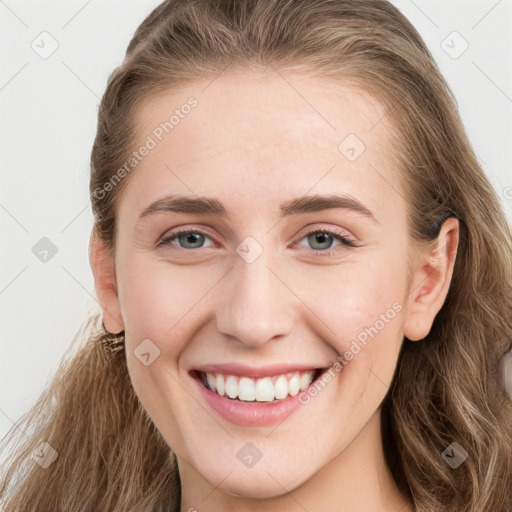 Joyful white young-adult female with long  brown hair and blue eyes