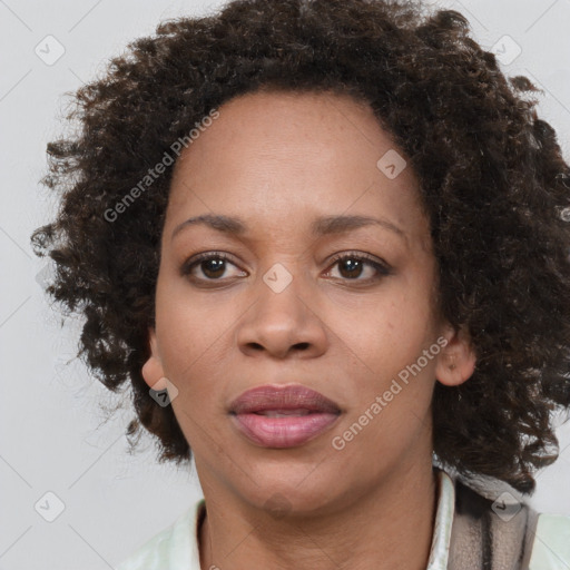 Joyful black adult female with medium  brown hair and brown eyes