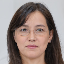 Joyful white adult female with long  brown hair and brown eyes