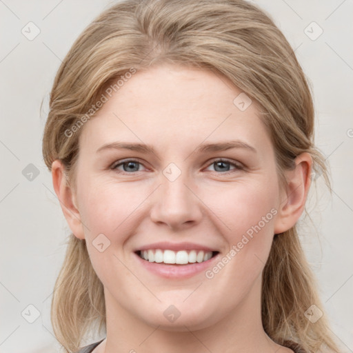 Joyful white young-adult female with medium  brown hair and blue eyes