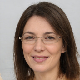 Joyful white adult female with long  brown hair and brown eyes