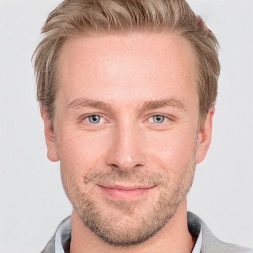 Joyful white adult male with short  brown hair and blue eyes