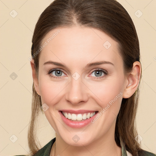 Joyful white young-adult female with long  brown hair and green eyes