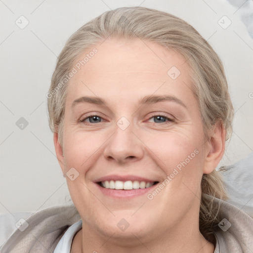 Joyful white adult female with medium  brown hair and blue eyes