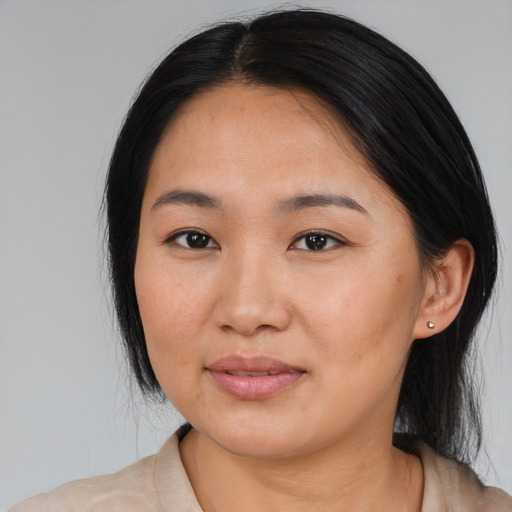 Joyful asian young-adult female with medium  black hair and brown eyes