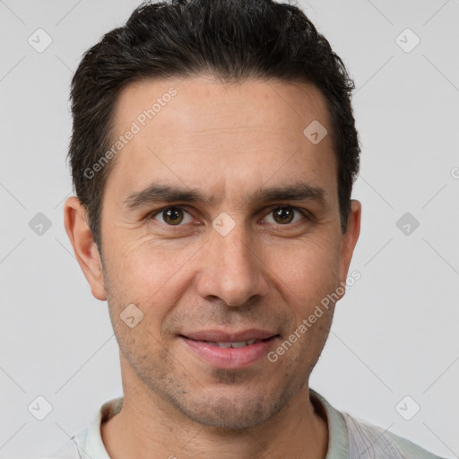 Joyful white adult male with short  brown hair and brown eyes