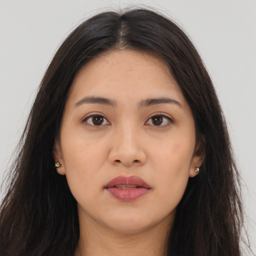 Joyful latino young-adult female with long  brown hair and brown eyes