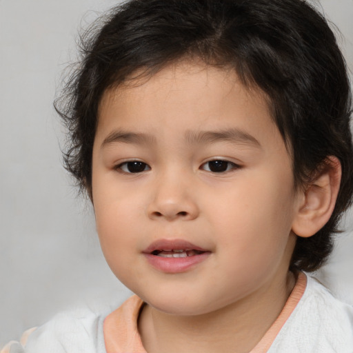 Joyful asian child female with medium  brown hair and brown eyes