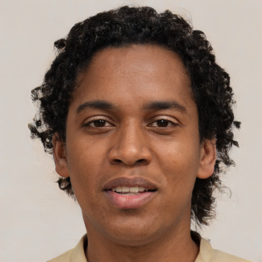 Joyful black young-adult male with short  brown hair and brown eyes
