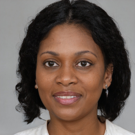 Joyful black young-adult female with medium  black hair and brown eyes