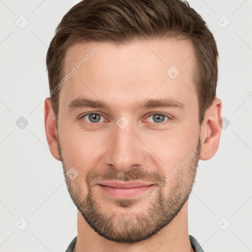 Joyful white young-adult male with short  brown hair and grey eyes