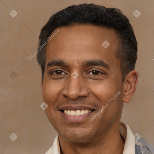 Joyful latino adult male with short  black hair and brown eyes