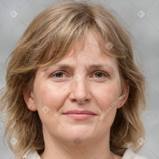 Joyful white adult female with medium  brown hair and grey eyes