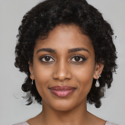 Joyful black young-adult female with medium  black hair and brown eyes