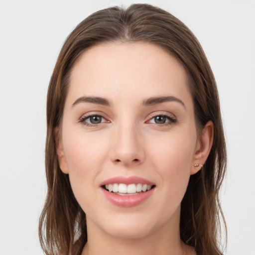 Joyful white young-adult female with long  brown hair and grey eyes