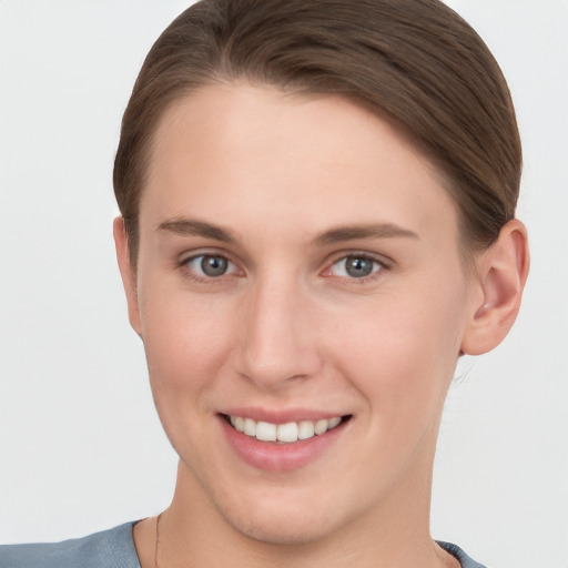 Joyful white young-adult female with short  brown hair and grey eyes