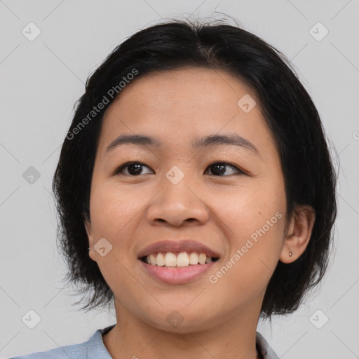 Joyful asian young-adult female with medium  black hair and brown eyes