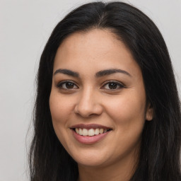 Joyful latino young-adult female with long  brown hair and brown eyes