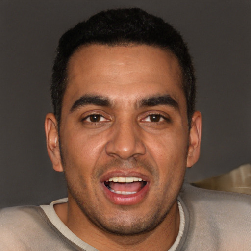 Joyful black young-adult male with short  black hair and brown eyes