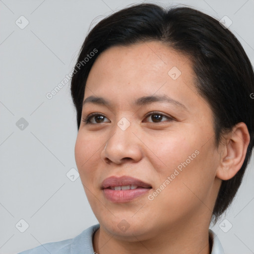 Joyful asian young-adult female with short  black hair and brown eyes